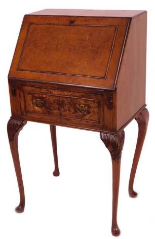 A mid 20thC walnut writing bureau, of slender proportion, with fall front and a fitted interior above one frieze drawer, with plate back handles, on four cabriole club legs, 96cm H, 53cm W, 37cm D.