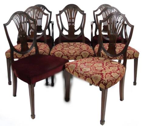 A harlequin set of eight 19thC Hepplewhite shield back chairs, with wheatsheaf splats, and two types of over stuffed material seats, on front square tapered legs terminating in spade feet, with two carvers, 103cm H.