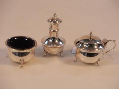 A George V silver three piece cruet set