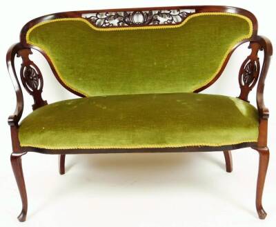 A late 19thC mahogany show frame salon suite, comprising of a two seater settee and armchair, each with pierced oval splats, oval pierced scroll and berry top rails and overstuffed backs and seats, in (later) green material, on front club legs, (the sette - 2