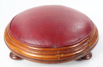 A late 19thC hassock or stool, of compressed circular form with overstuffed leather top, on four shaped feet, 9cm H, 34cm Dia.