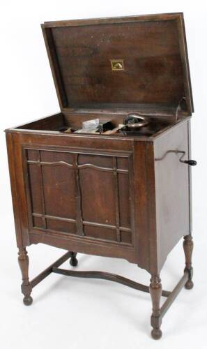 A 20thC HMV His Masters Voice wooden cased gramophone, numbered 16 to the arm, White and Sentance retail label, the rectangular cabinet fronted by a material speaker front, with compressed domed lid and part fitted interior with articulated arm, baize li