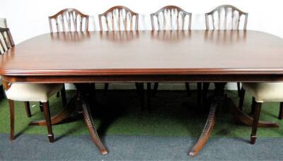 A matched 20thC dining room suite, comprising of eleven mahogany Hepplewhite style shield back dining chairs, each with overstuffed seats in straw coloured material, with serpentine fronts, on square tapering legs terminating in spade feet, 87cm H, and a - 2