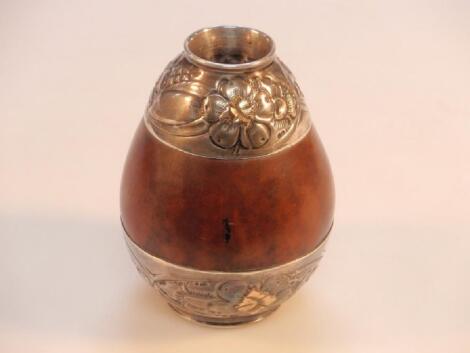 A coquille nut vessel with white metal floral mounts