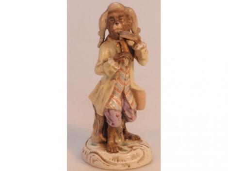 A 19thC German porcelain figure of a monkey playing a wind instrument (AF)