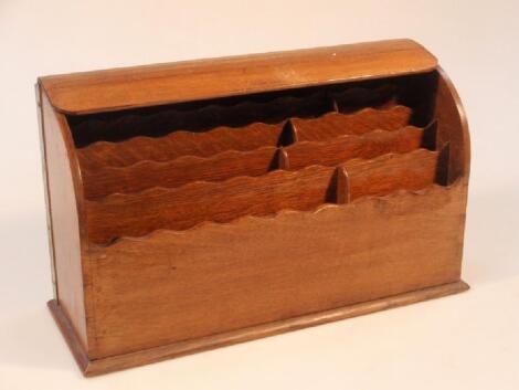 An early 20thC oak stationery box with a tambour cover