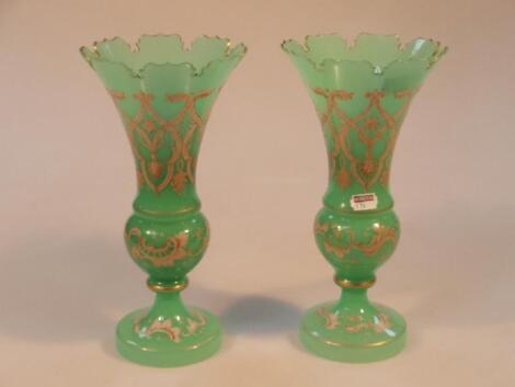 A pair of late 19thC green glass vases