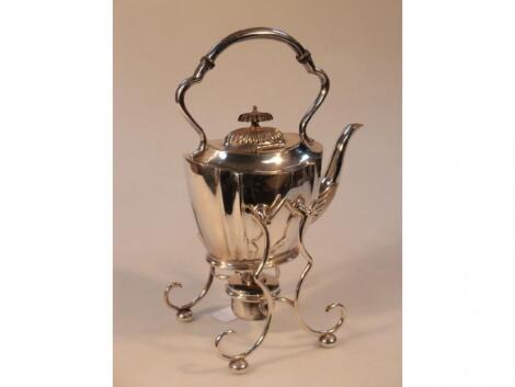 An early 20thC electroplated tea kettle with a fixed overhead handle on