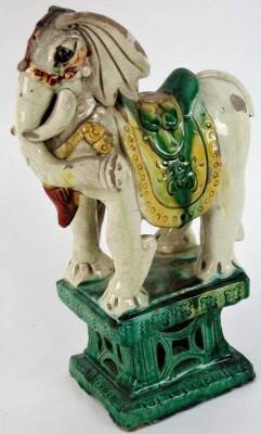 An antique Chinese T’ang style glazed elephant, (much damage), 30cm H.