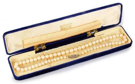 A graduated pearl necklace, with diamond and white gold clasp, 42cm long.