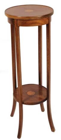 An Edwardian mahogany plant stand, the circular top on sabre legs, with sun inlay and further shelf beneath, 102cm H, 35cm Dia.