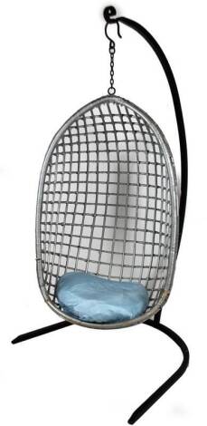 A hanging basket weave pendulum chair, of pierced egg shape form, with heavy metal hook to the main body, attached to a metal stand, 113cm H, 68cm W, 52cm D.