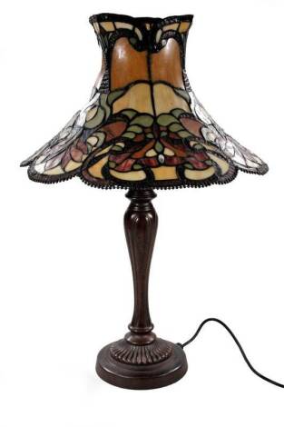 *An as new two branch table lamp, with Tiffany style shade decorated with flowers predominately in green and cream, 67cm H.