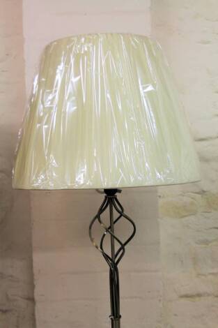 *An as new electrical standard lamp, on entwined cylindrical stem and circular foot, with shaped shade, 168cm H.