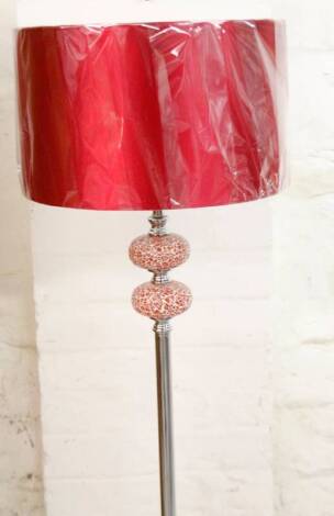 *An as new electrical standard lamp, with cylindrical stem on circular foot, with circular shade in red, 156cm H.