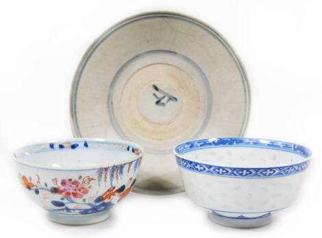 A 19thC porcelain tea bowl, of circular form, polychrome decorated in Imari colours, predominately in orange, blue and green, on a circular foot, a blue and white porcelain bowl, D & S Howlett Collection label beneath, no.502, and a Ming porcelain dish, o