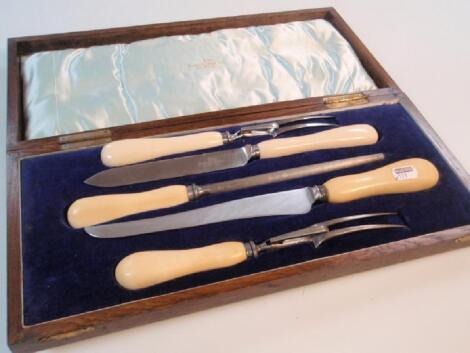 An oak cased carvery set with ivory handles