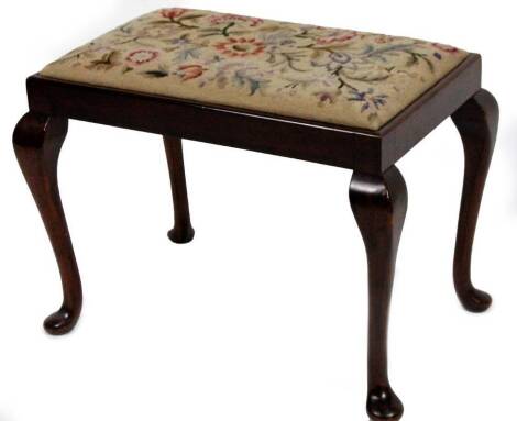 An early 20thC mahogany stool, of rectangular form on cabriole supports with drop in seat (later) petit point floral cover, 48cm H, 63cm W, 40cm D.