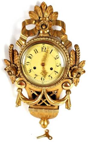 A French giltwood cartouche shaped wall clock, 8 day movement, decorated with flowers, leaves, etc., 52cm H.