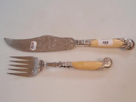 A pair of ivory pistol handled electroplate fish servers