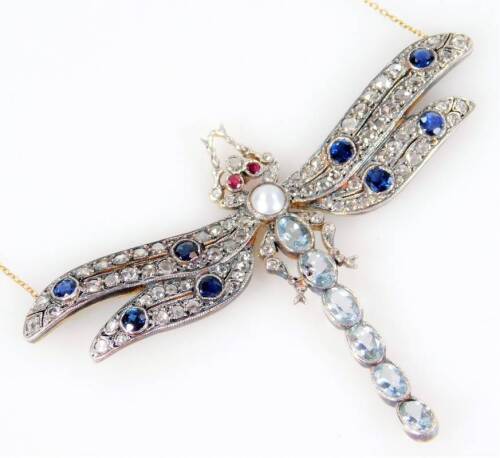 A dragonfly necklace, the dragonfly set with two rubies for eyes, sapphire and diamond wings, and a cultured pearl and aquamarine body, the wings each set with two sapphires and two rows of diamonds, in a white metal setting, gold coloured to reverse, unm