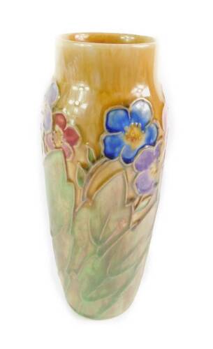 A Royal Doulton stoneware early 20thC vase, of ovoid form, tube line decorated with flowers and bold leaves against a mottled brown ground, impressed marks, 23cm H.