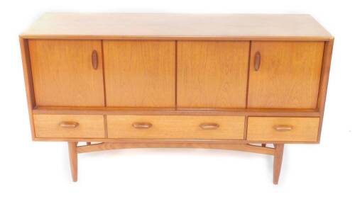 A G-Plan 1960’s teak sideboard, with a pair of bi-fold drawers over one long drawer flanked by two short drawers, raised on turned legs, 81.5cm H, 145cm W, 45.5cm D.