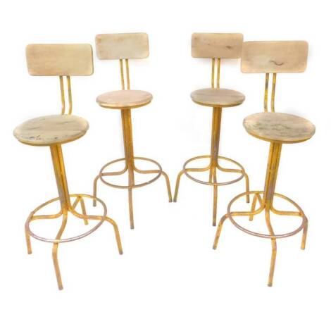 A set of four late 20thC beech and yellow painted metal bar stools, distressed finish, Retailed by Andy Thornton, 116cm H.