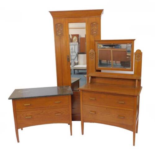 A Victorian oak bedroom suite with Art Nouveau floral carved detailing, comprising a single wardrobe, 200cm H, 92cm W, 46.5cm D, with outswept pediment over a single bevelled glass mirrored door, raised on a plinth base, black marble topped wash stand, wi