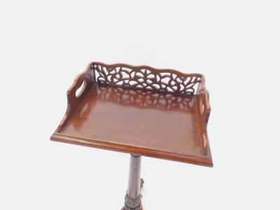 A Regency and later mahogany book stand, the rectangular top with fret work back and two side carrying handles, over a turned and lappet carved column, above a trefoil base with carved scrolling on fluted feet, 86cm H, 40cm W, 36cm D. - 2