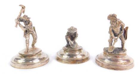 Three place setting holders modelled as gold prospectors, each raised on a circular base, stamped 925, 6.82oz.