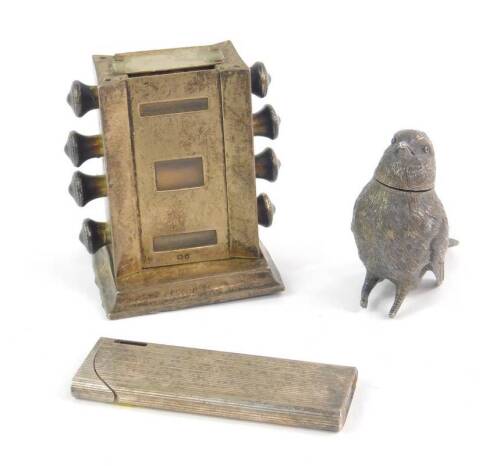 An Edward VII silver perpetual desk calendar, Birmingham 1907, a silver pepperette modelled as a bird, London 1903, (AF), and a Japanese white metal pocket lighter with engine turned decoration. (3)