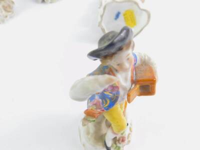 A Samson Derby porcelain figure of a seated lady playing a lute, aside a lamb, with floral bocage, raised on a rococo scroll base, 14cm H, together with a late 19thC German porcelain figure of a grape seller, 16cm H, and two further porcelain figures. (4 - 2