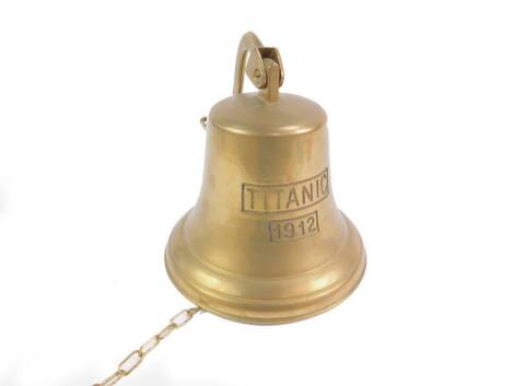 A brass replica of a Titanic ships bell, engraved Titanic 1912, 14cm H.