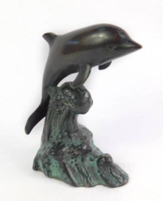 A bronze figure of a dolphin, modelled riding on the crest of a wave, 16cm H.