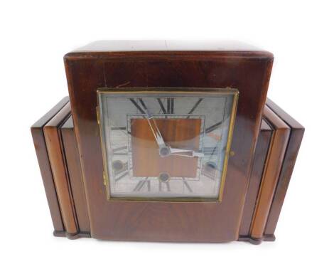 An Art Deco mahogany three colour cased mantel clock, silvered square dial bearing Roman numerals, Continental 8-day movement with Westminster chimes, No.3548, with key, 26cm H, 32cm W, 13cm D.