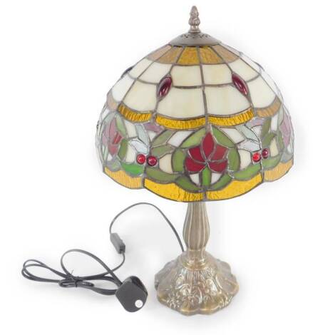 *A Tiffany style table lamp with floral and jeweled decorated shade, raised on a leaf molded faux metal base, 48cm H, 29cm Dia. (boxed)