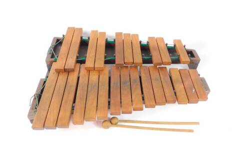 A wooden xylophone, two section, 25 notes, with mallets, cased.