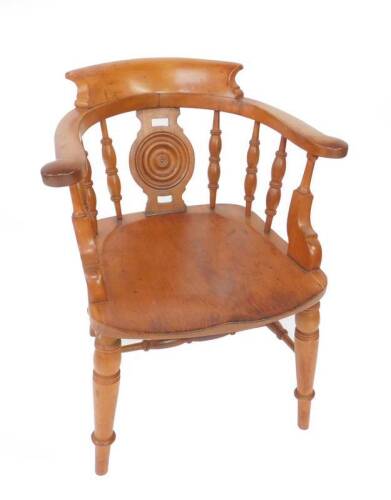 A Victorian mahogany smoker’s bow chair, with bulls eye splat and turned spindles, raised on turned legs, united by stretchers.