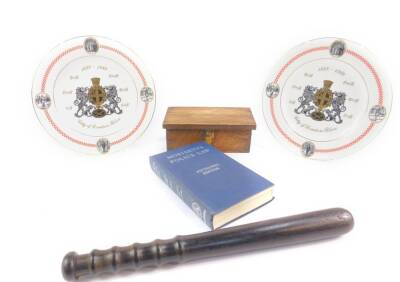 A City of London Police ebony truncheon, City Police oak keys box, Moriaty’s Police Law, 15th edition, and a pair of Spode porcelain plates commemorating the 150th anniversary of the City of London Police. (5)