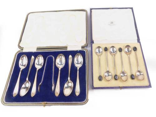 A set of six George V silver teaspoons, and a pair of sugar tongues, with stipple floral engraving, Sheffield 1923, together with six coffee spoons with bean terminals, Sheffield 1924, both cased, 4.1oz all in.