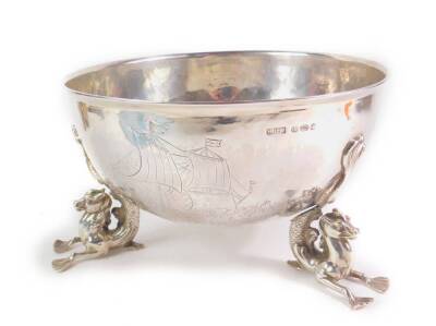 A Hanau silver marine bowl, with engraved decoration of sailing ships on a choppy sea, raised on three hippocampus feet, B. Neresheimer & Söhner, import marks Berthold Hermann Muller, London 1912, 26.92oz. (AF - one foot completely loose, but we have piec