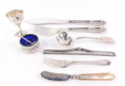 A George IV silver cream ladle, initial engraved, William Eaton, London 1828, George V silver circular pierced salt raised on three ball feet, with blue glass liner, Birmingham 1912, a Victorian silver salt spoon, Edward VII silver fluted egg cup, Sheffie