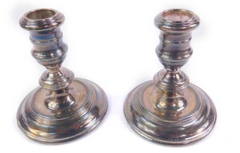 A pair of loaded silver squat candlesticks, Birmingham 1959, 14.92oz all in, 10.5cm H.