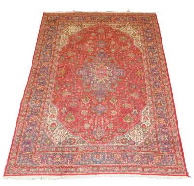 A Tabriz rug, red and blue, 338cm x 245cm.