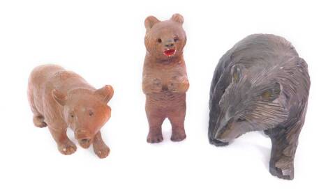 Three Black Forest type wooden carvings of bears, one modelled standing, two on all fours.