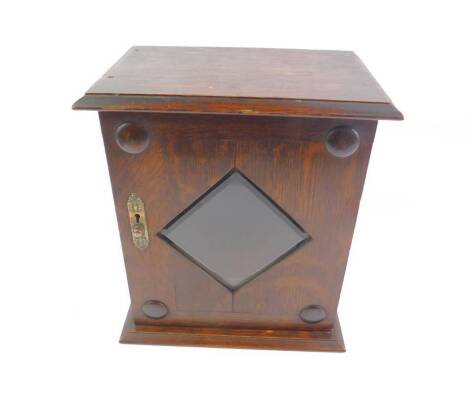 A Victorian oak smoker’s cabinet, the door enclosing a diamond bevelled glass, with fitted interior, raised on a plinth base, 31.5cm H, 27cm W, 18cn D.