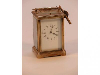 A gilt metal carriage clock