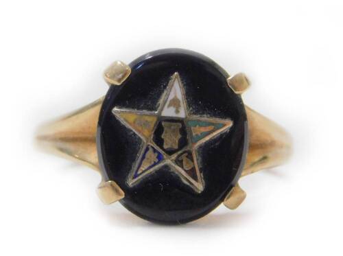 A Romany Masonic black onyx ring, with oval black agate stone centre, with raised gold star motif of varying enamel colour and design, on a yellow metal band stamped Romany 10k, size S, 4.1g all in.