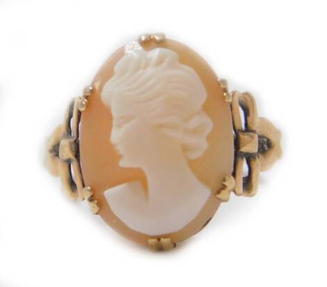 A cameo dress ring, with claw set oval cameo of lady looking left, with bow shaped shoulders, yellow metal marked 9ct, size L, 2.8g all in.